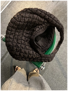 Detailed top view of a black quilted cloud hobo bag showing zip closure and soft padding