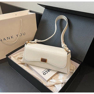 Chic ivory faux leather baguette bag with gold buckle in an elegant gift box presentation
