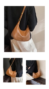 Detail of a brown polished leather hobo bag with vertical stitching and gold buckle