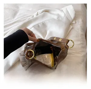 Top view of brown leather bag interior showing zipper and large metal ring detail