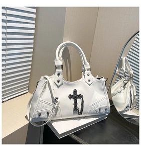 Detail of white pebbled leather motorcycle bag with silver studs and cross charms
