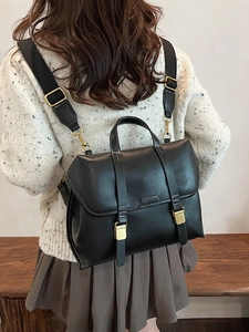 Retro matte black PU leather backpack with white contrast stitching and gold metal buckles