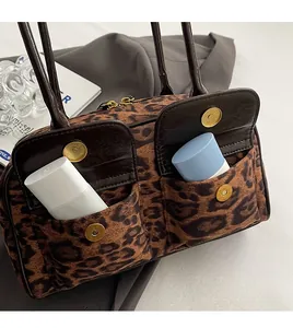 Detail of leopard print handbag showing front magnetic pockets with storage space