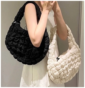 Quilted cloud shoulder bag detail featuring textured puff fabric in black and beige colors