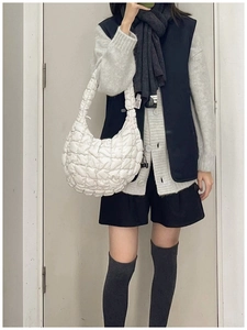 Detail of white quilted puffy cloud bag with soft textured fabric and spacious design