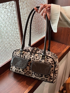 Vintage leopard print suede bowling bag with deep brown leather trim and golden hardware