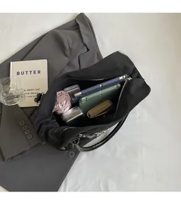 Top view of spacious black canvas tote interior showing capacity for tablet and umbrella