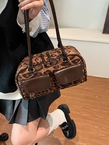Chic leopard print bowling bag for women featuring double brown pockets and gold hardware