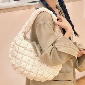Chic white quilted cloud bag featuring a puffy texture and a soft shoulder strap design