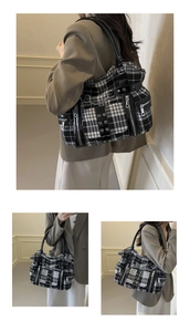 Detail view of gothic punk plaid tote bag with silver metal chains and rivet accents