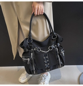 Detail view of large gothic punk tote bag showing metal eyelets and silver chains