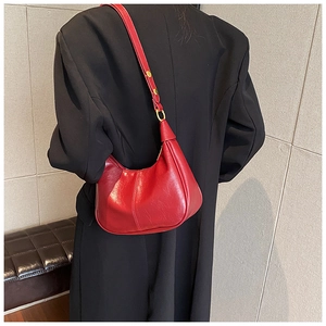 Detailed back view of a dark red hobo bag on a model wearing a black blazer