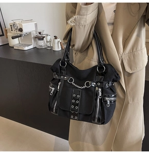 Detailed view of Gothic punk tote bag showing metal rings, silver chains and functional zippers