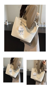 Detailed views of beige wrinkled leather tote bag with cute cloud charm and dual straps