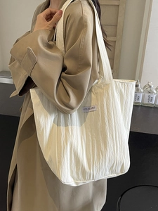 White pleated canvas tote bag with shoulder straps and KISS YOURSELF label for daily use