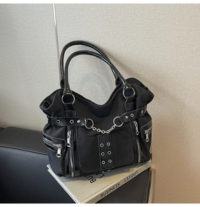 Detail view of gothic punk tote bag showing multi-pocket design and silver metal chains