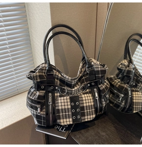 Detail of gothic punk plaid tote bag with silver studs, metal chains and zippers