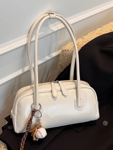 Retro cream white baguette shoulder bag with baseball charm on black blazer jacket