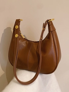 Vintage brown leather crescent underarm bag with gold hardware and vertical stitching detail