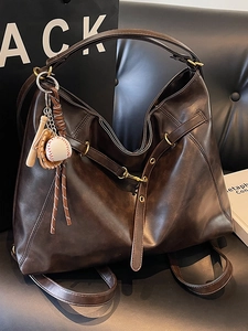 Brown large capacity tote bag with baseball charms and adjustable shoulder strap