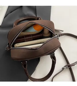 Top view of dark brown suede Boston bag interior showing spacious main compartment