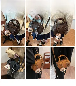 Three colors of retro bowling cross-body bags styled with lion plush and heart charms