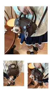 Detailed view of vintage dark brown Boston bag with a cute plush bear and heart charm