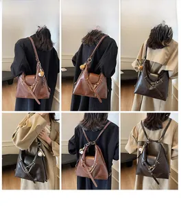 Detalle de mochila vintage de cuero PU con correas versátiles y colgante de osito