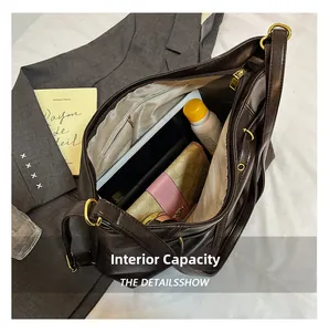 Detail view of large capacity interior for brown leather tote bag with functional pockets
