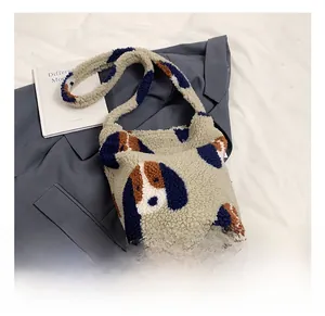 Detail of soft beige sherpa tote bag featuring cute blue and brown dog patterns