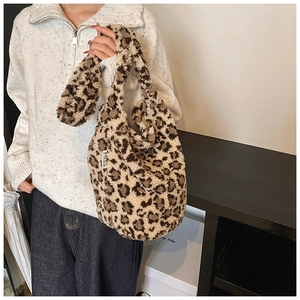 Detail of soft leopard print plush tote bag featuring a MISS label and crossbody strap