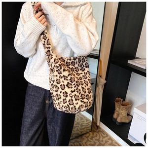 Detail of soft leopard print faux fur tote bag featuring a white MISS brand tag