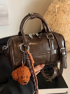 Brown polished PU leather bowling bag with teddy charm and adjustable shoulder strap