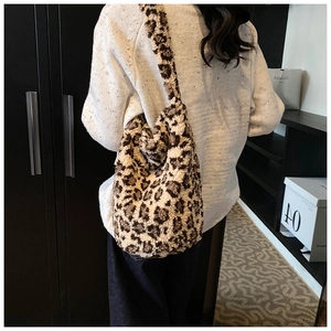 Detail of soft leopard print plush fabric on large capacity tote bag worn by model