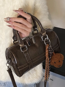 Dark brown PU leather Boston bag with triple zippers and cute bear charm shown with model