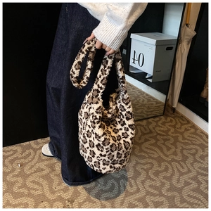 Detail shot of plush leopard print hobo bag with thick faux fur texture and wide strap