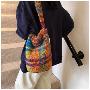 Close-up of the fuzzy colorful checkered lamb wool tote bag with soft plush texture