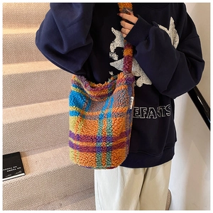 Detail view of colorful checkered fuzzy plush tote bag with thick soft fleece texture