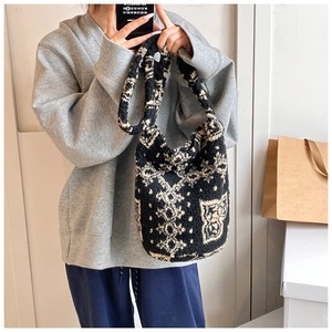 Detail of soft lamb wool tote bag with black and white retro geometric print pattern