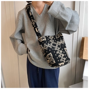 Detail of soft lamb wool crossbody bag showing contrast pattern on casual tote
