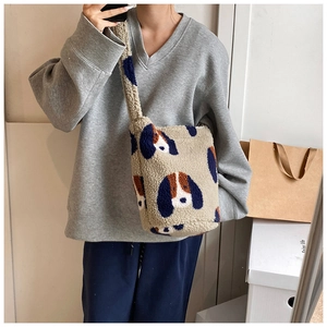 Mirror selfie showing the fit of the plush beige tote bag with cute dog prints