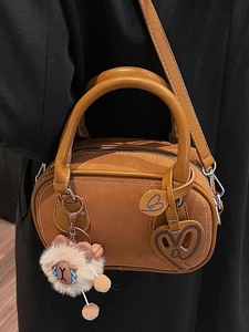 Brown suede mini Boston bag with plush pendant and adjustable leather shoulder strap