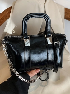 Elegant black glossy leather handbag with silver G-chain strap for business chic style