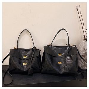 Detailed comparison of two black crocodile pattern tote bags with gold twist locks