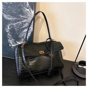 Detailed view of black crocodile pattern leather tote with premium gold rotating lock