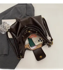 Top-down view of spacious dark brown tote bag interior with zipper pocket and metal hardware