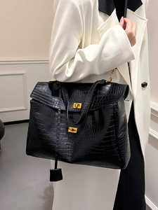 Elegant black crocodile embossed tote bag with gold twist lock and spacious interior