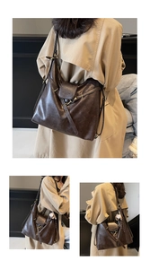 Detail view of large dark brown retro tote with matte texture and baseball charm