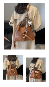 Detail of a brown vintage PU leather hobo bag showing versatile straps and metal buckle
