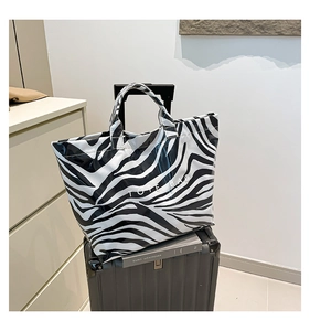 Fashionable zebra print PVC tote bag on luggage for travel and stylish commuting